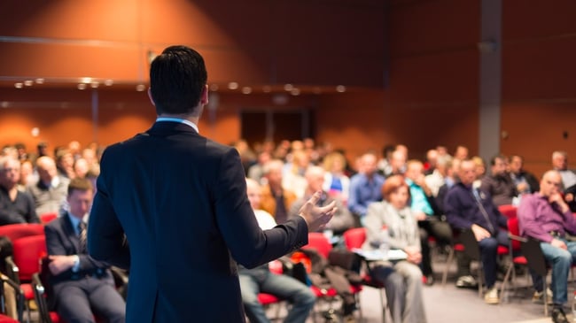 A businessman speaking at a conference