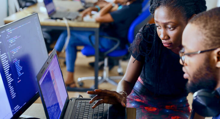 A Man and Woman Working on a Laptop