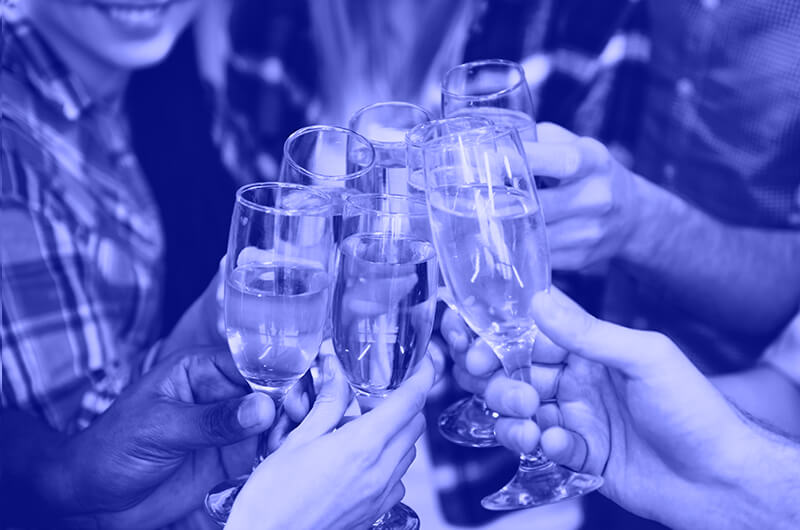 Blue Image of Seven People Tapping Prosecco Glasses