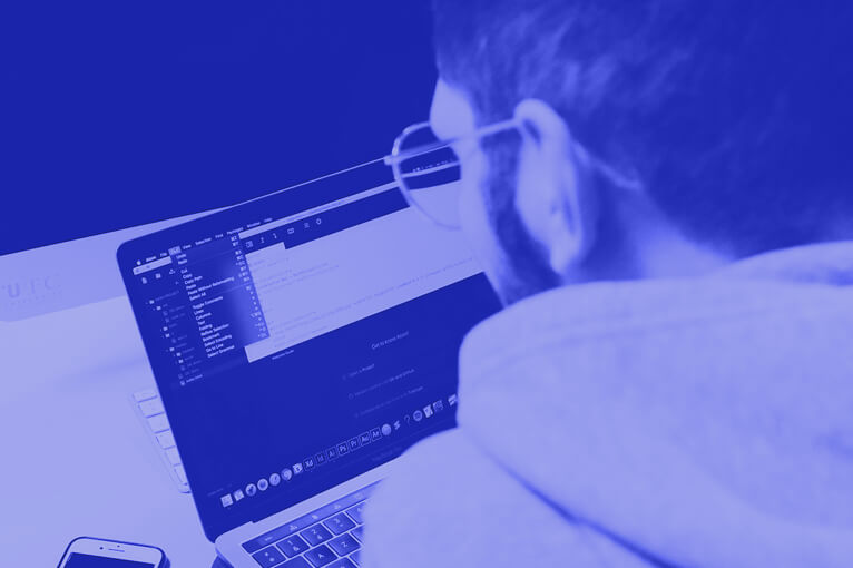 Blue Image of a Man Working on a Laptop
