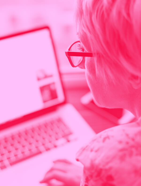 Pink Image of a Woman Working on a Laptop