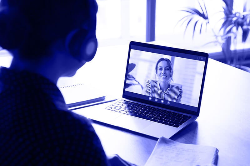 Blue Image of a Woman Talking to another Woman through a Video Call on a Laptop