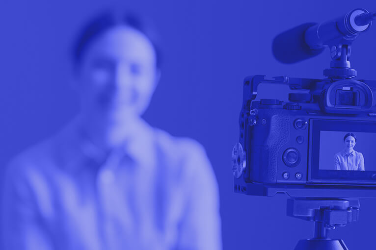 Blue Image of a Camera Recording a Woman